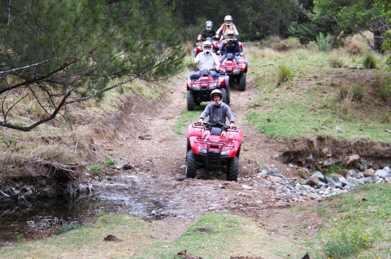 Guided quad bike tour crossing a creek